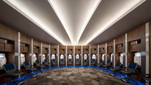 LA Clippers basketball locker room in half-horseshoe layout staged for gameday with jerseys hanging
